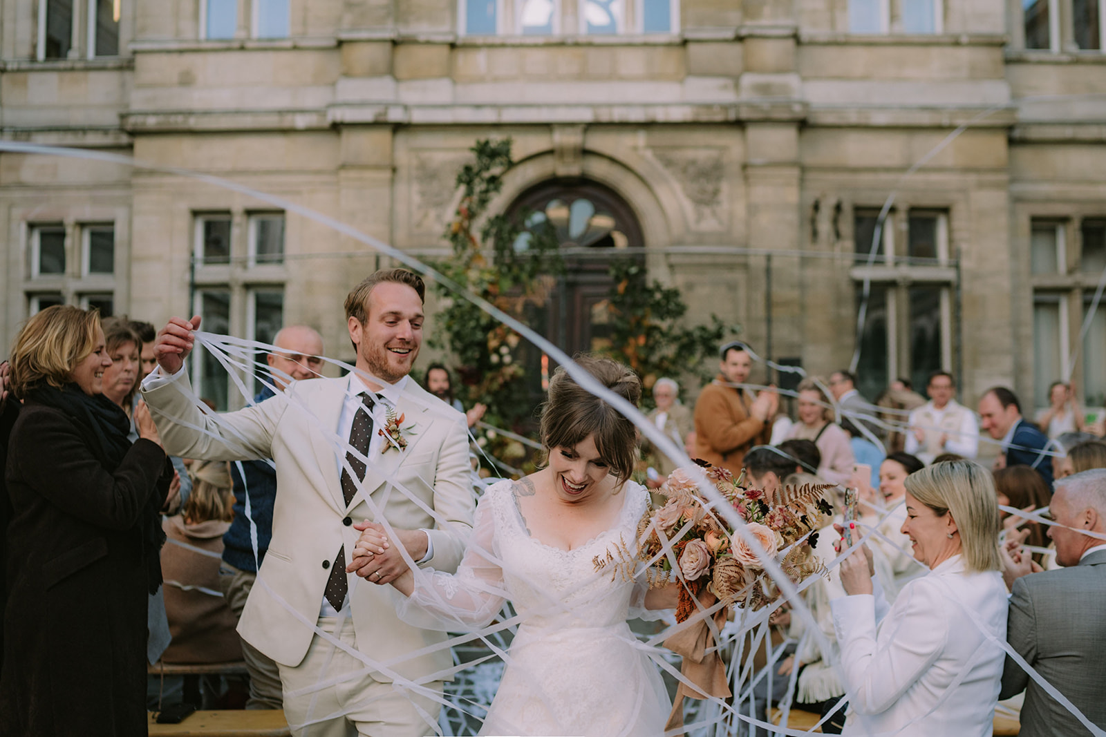 bride and groom exit the ceremony with confetti