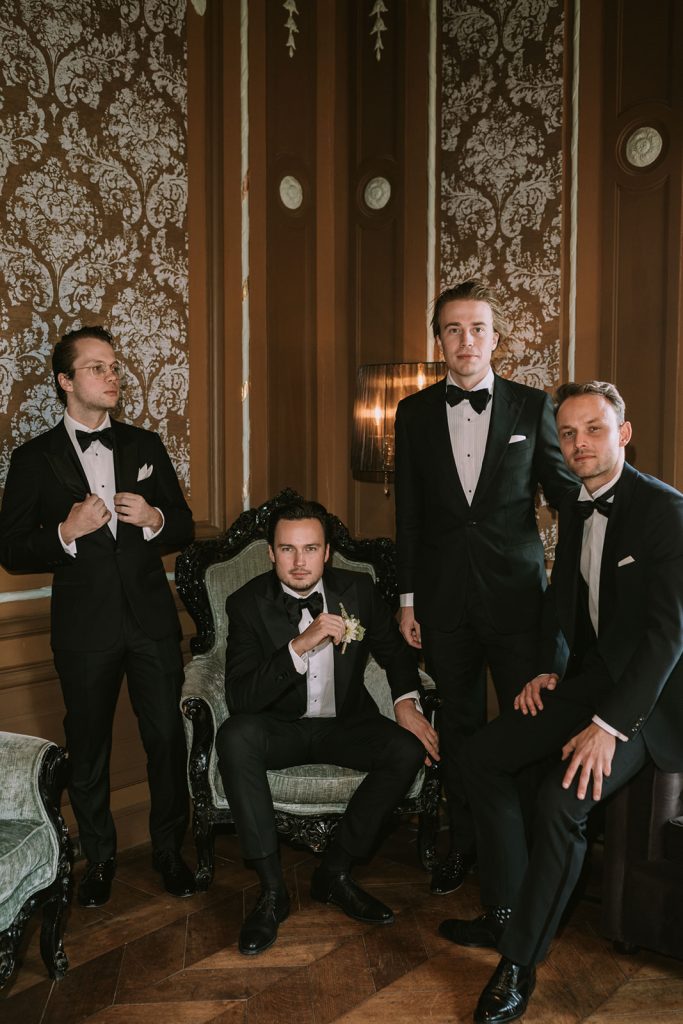 Editorial wedding photographer capturing the groomsmen in a stylish bar